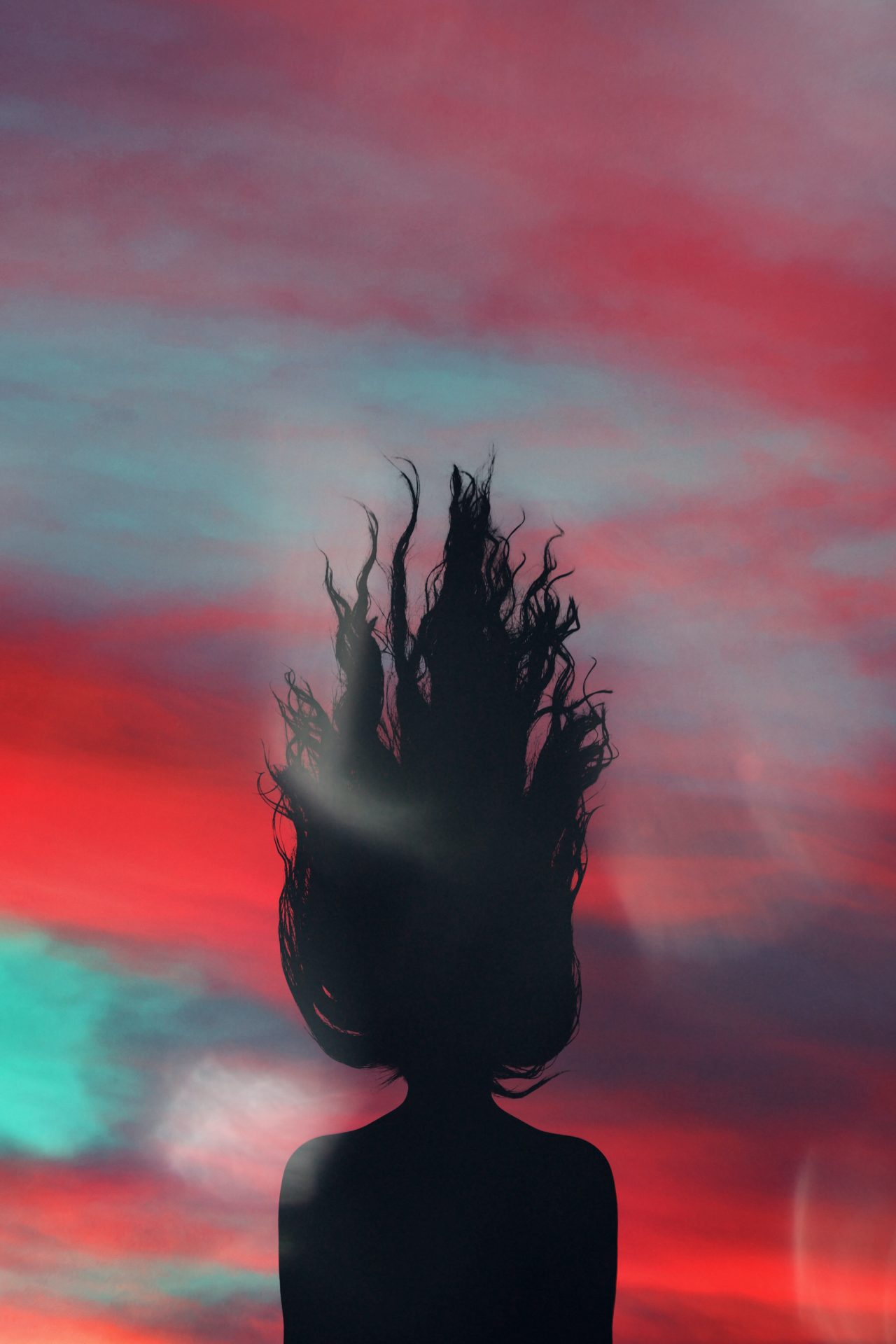 silhouette of woman facing on sky